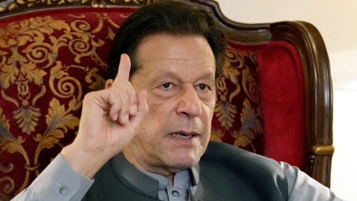 FILE - Pakistan's former Prime Minister Imran Khan gestures during talk with reporters regarding the current political situation and the ongoing cases against him at his residence, in Lahore, Pakistan, on Aug. 3, 2023. A Pakistani court Tuesday Nov. 28, 2023 ordered a public trial in prison of former Prime Minister Imran Khan on charges of revealing official secrets, his lawyer said. (AP Photo/K.M. Chaudary, File)