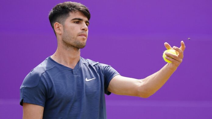 Carlos Alcaraz is distracted by an insect during his match against Jack Draper (not pictured) on day six of the cinch Championships at The Queen's Club, London. Picture date: Thursday June 20, 2024.