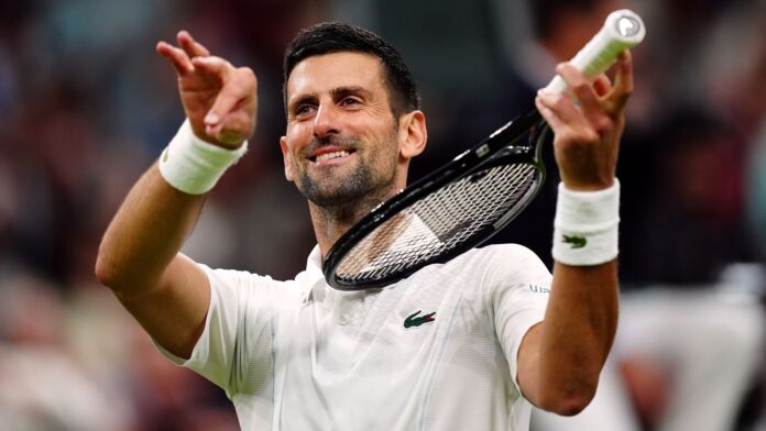 Novak Djokovic pretends to play a violin after beating Holger Rune on day eight of the 2024 Wimbledon Championships at the All England Lawn Tennis and Croquet Club, London. Picture date: Monday July 8, 2024.