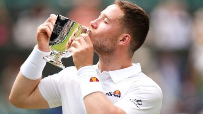 Great Britain's Alfie Hewett celebrates with the trophy following victory against Martin de la Puente (not pictured) in the Gentlemen's Wheelchair Singles Final on day fourteen of the 2024 Wimbledon Championships at the All England Lawn Tennis and Croquet Club, London. Picture date: Sunday July 14, 2024.