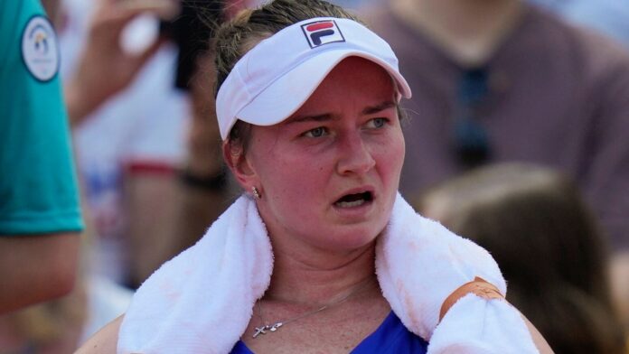 Barbora Krejcikova of Czech Republic cools off during a break as she plays Elina Svitolina of Ukraine during their women's singles third round match at the Roland Garros stadium, at the 2024 Summer Olympics, Tuesday, July 30, 2024, in Paris, France. (AP Photo/Andy Wong)